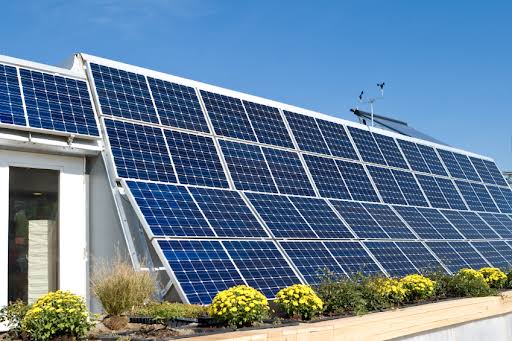 Solar energy technician examining photovoltaic equipment